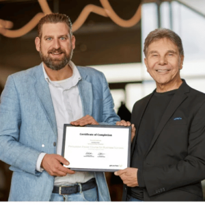 Dr Cialdini and Bas Wouters holding a Certificate