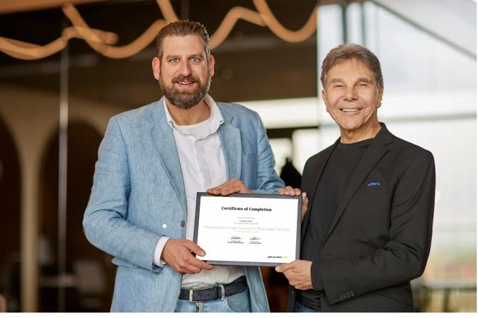 Dr Cialdini and Bas Wouters holding a Certificate