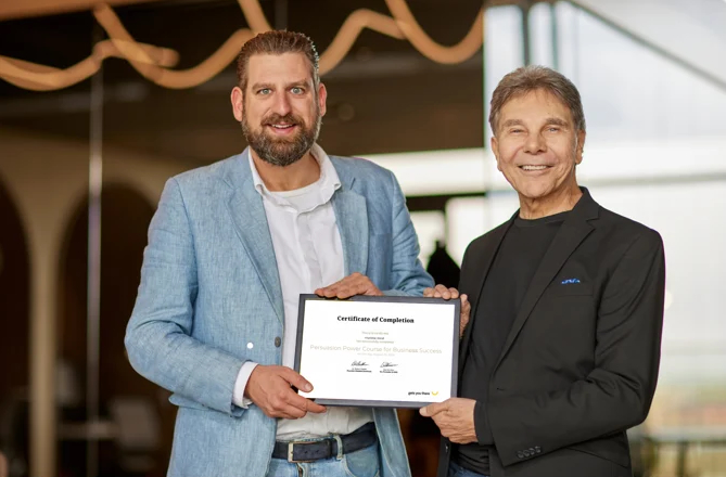 Cialdini and Bas holding certificate