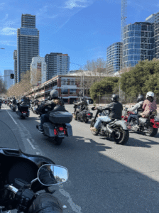 Motorcycle riders form one long string through Melbourne enjoying their ride.